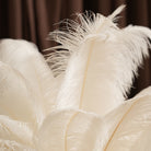 Banquet table decor with multiple white feather centerpieces
