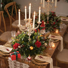 Large red bow christmas hoop arch pre-filled with red rose and winter greenery arrangements