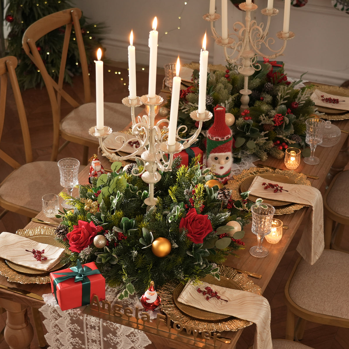 Large red bow christmas hoop arch pre-filled with red rose and winter greenery arrangements