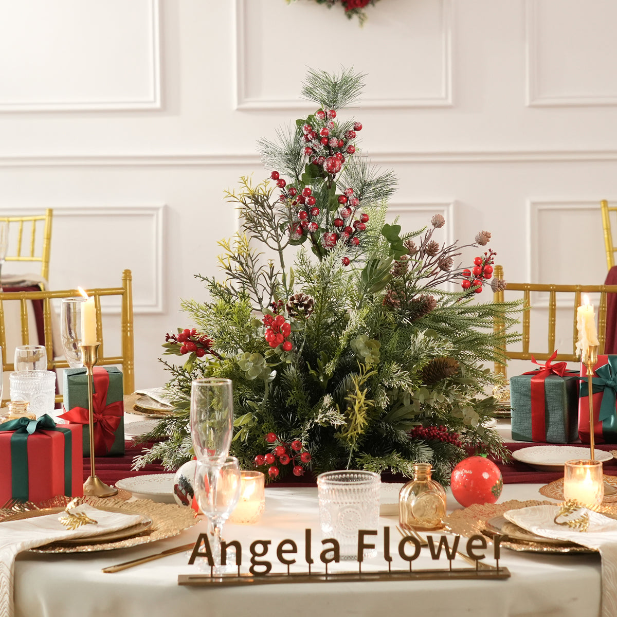 Frosted pine sprig red berry table arrangement for winter holiday parties