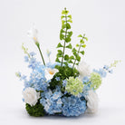 Close‑up indoor shot of mixed silk hydrangea, rose and calla lily table centerpiece