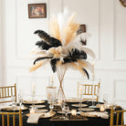 Ostrich feather centerpieces lining long banquet wedding table