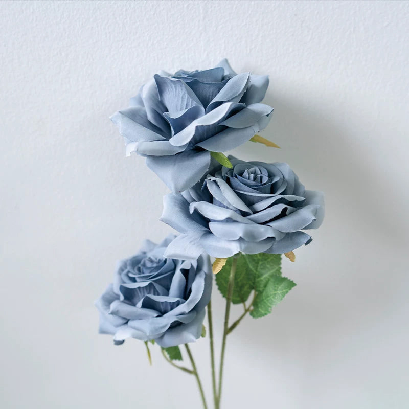 pastel‑blue‑faux‑rose‑in‑glass‑vase‑scene

