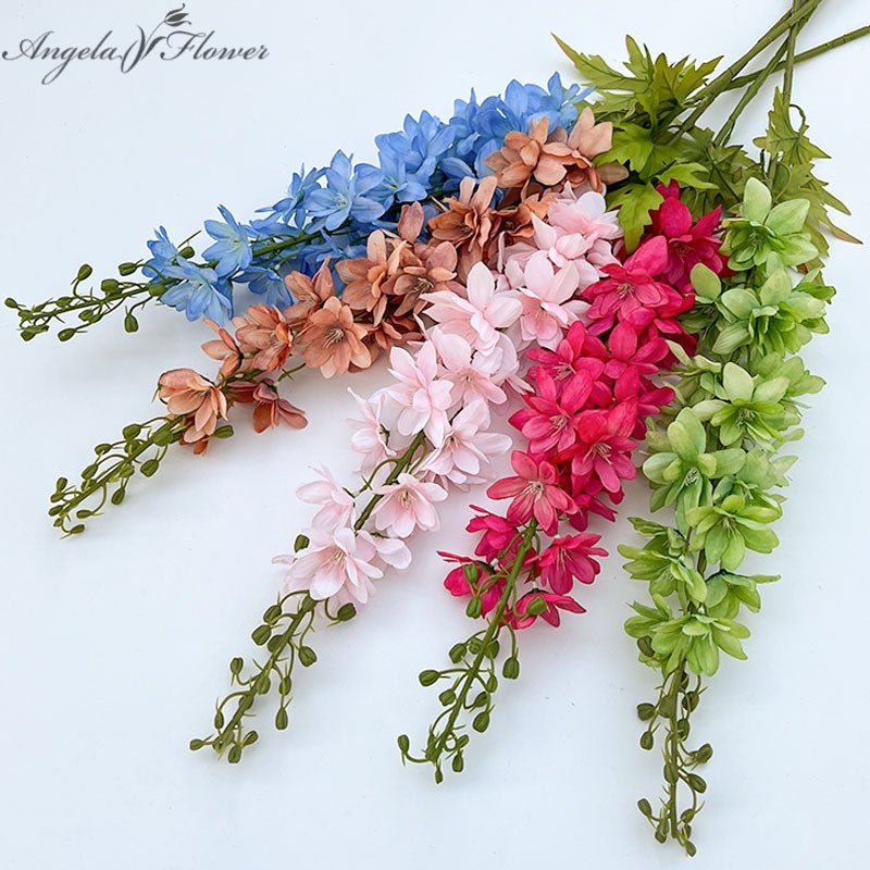 multicolor‑artificial‑delphinium‑stems‑flat‑lay‑white‑background
