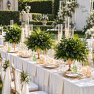 Tall tropical greenery table centerpiece to match gold metal flower stand