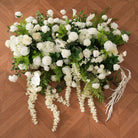Fine sprengeri green foliage mixed with white blooms on arch
