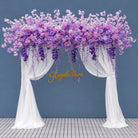 Romantic purple floral arch display with sheer curtain