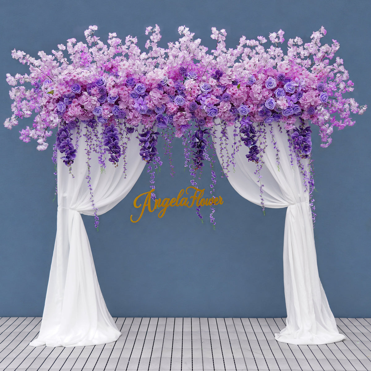 Romantic purple floral arch display with sheer curtain