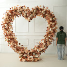 Warm earth tone heart flower arch outdoor wedding
