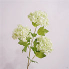 Faux hydrangea blooms with green leaves, wedding flower