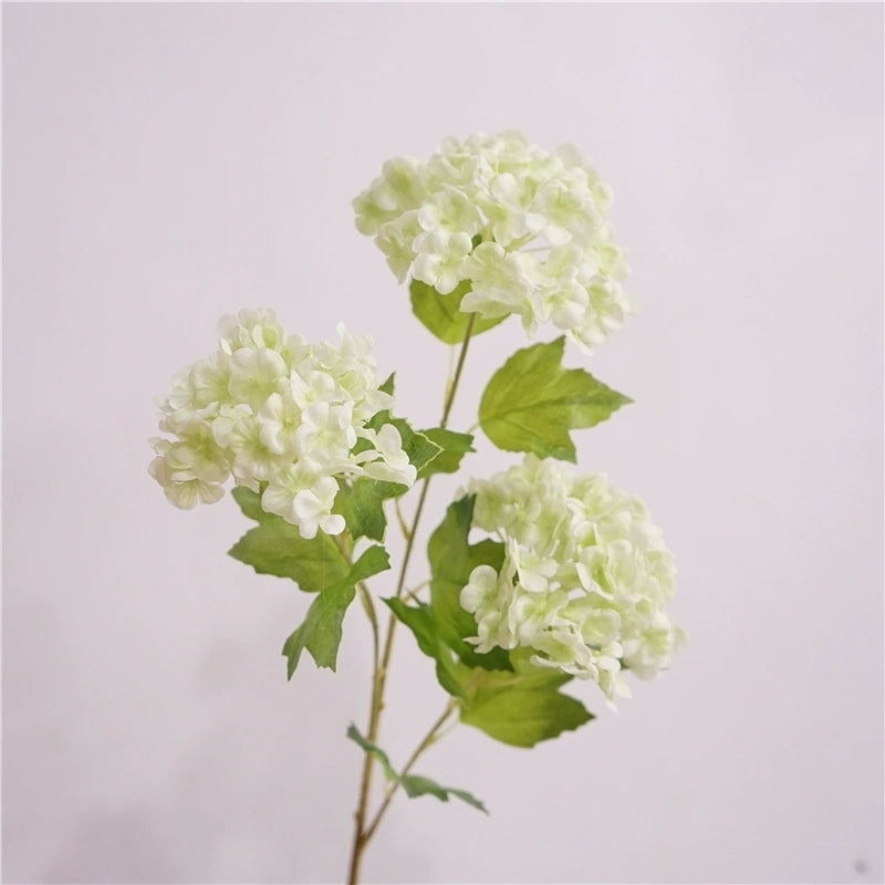 Faux hydrangea blooms with green leaves, wedding flower