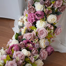 Close-up shot of mixed artificial peonies, dusty mauve roses, white blooms 