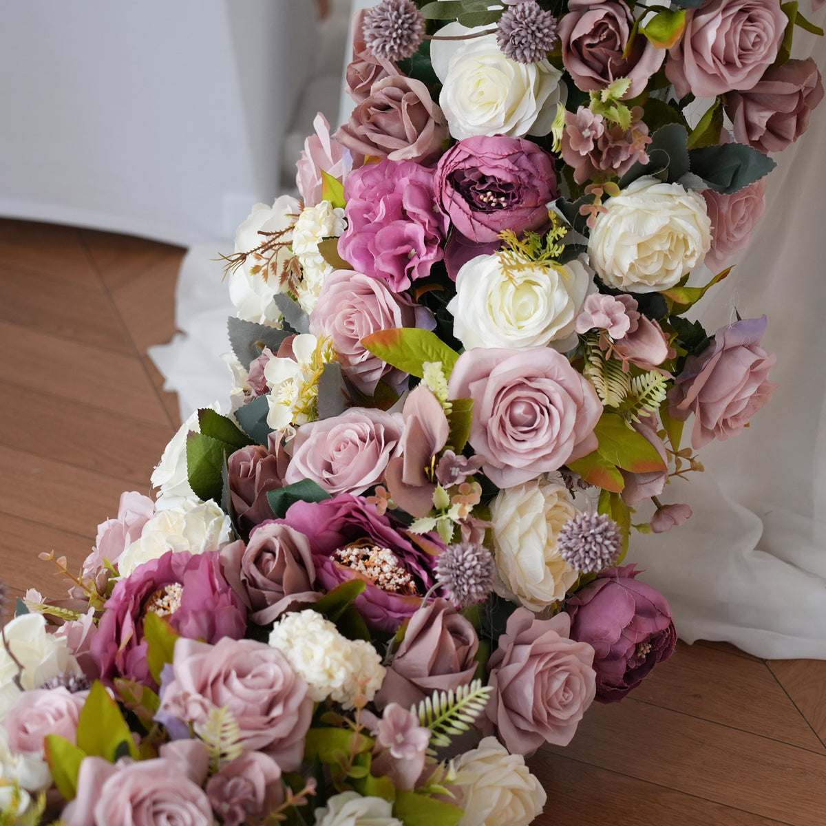 Close-up shot of mixed artificial peonies, dusty mauve roses, white blooms 