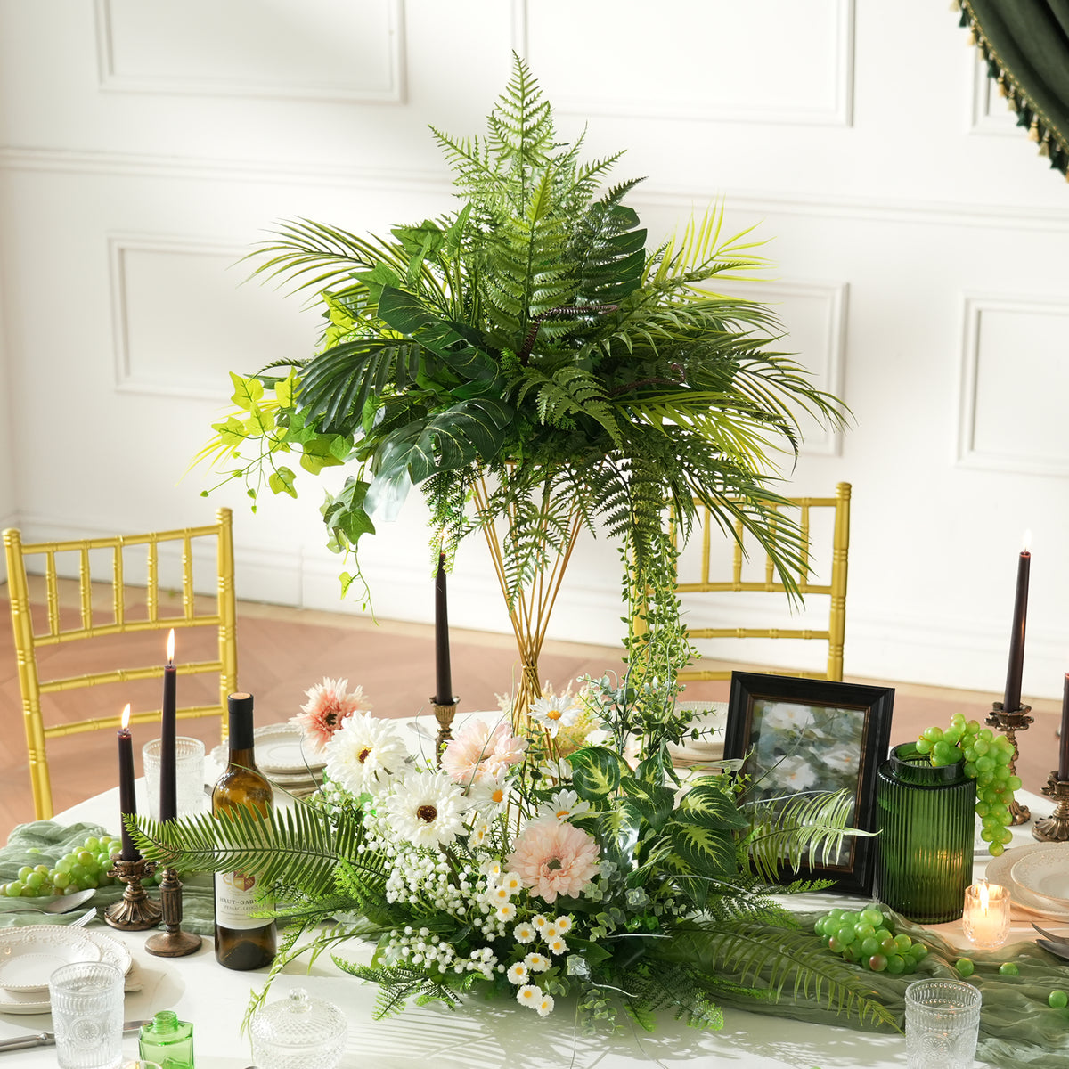 Greenery centerpiece against white panel background