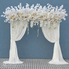 Ivory blossom arch styled with reception table flowers