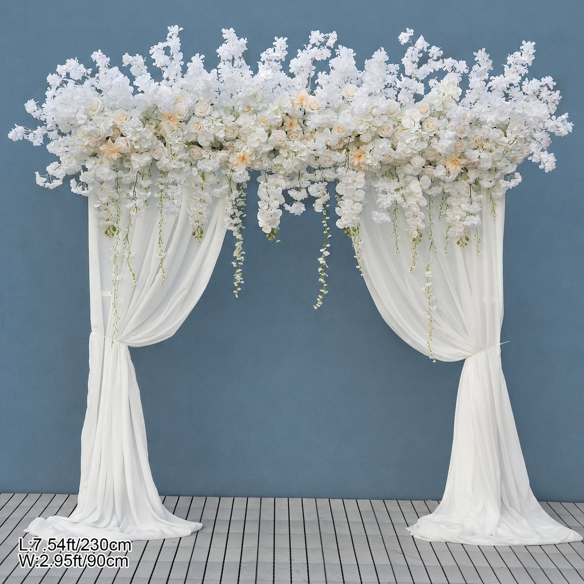 Ivory blossom arch styled with reception table flowers