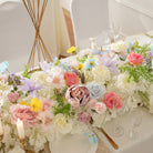 Tall gold stand rose flower ball centerpiece paired with table flower row