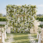 White and green artificial flower wall backdrop, lush silk roses mixed greenery panel for wedding photo booth reception decor