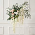 Boho artificial flower decor on irregular curved wall mirror