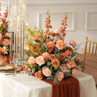 Orange delphinium spike accent within peach rose table centerpiece for autumn weddings