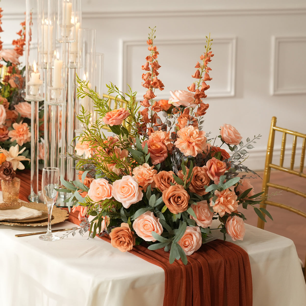 Orange delphinium spike accent within peach rose table centerpiece for autumn weddings