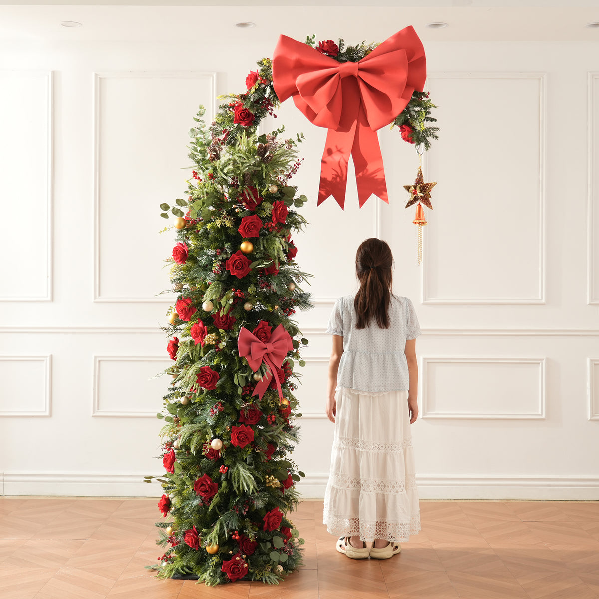 Winter floral swag with orange dried pods, long pine needles, red berries and artificial red roses