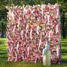 Bride and groom portrait in front of pink rose wisteria flower wall 