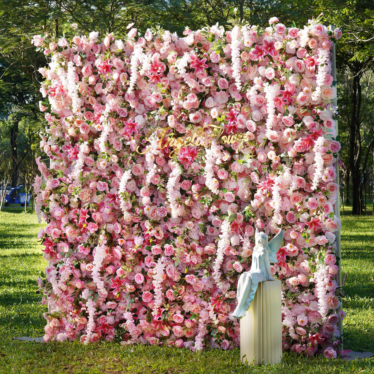 Bride and groom portrait in front of pink rose wisteria flower wall 