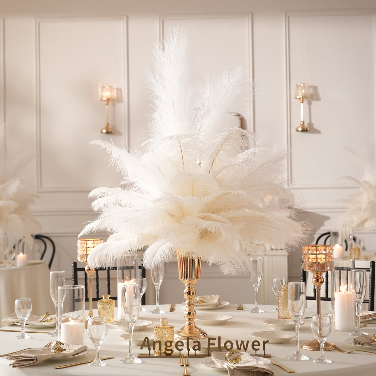 Elegant indoor dining table styled with black ostrich feather centerpiece and candles