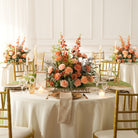 Outdoor garden wedding tablescape with long table lined with peach rose artificial florals