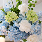 Cool‑toned blue‑green mixed artificial flower centerpiece for summer wedding events