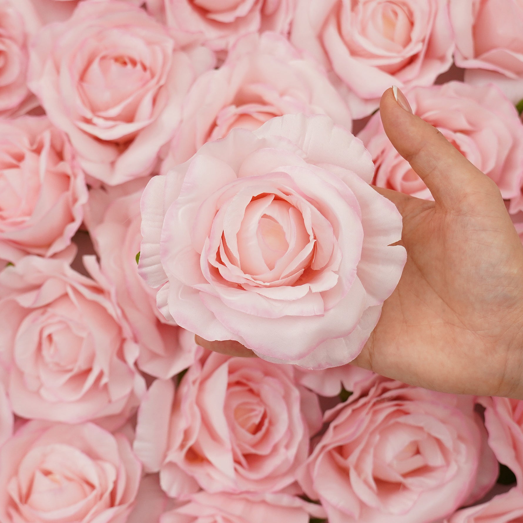Soft silk roses in multiple shades for wedding flower arrangements