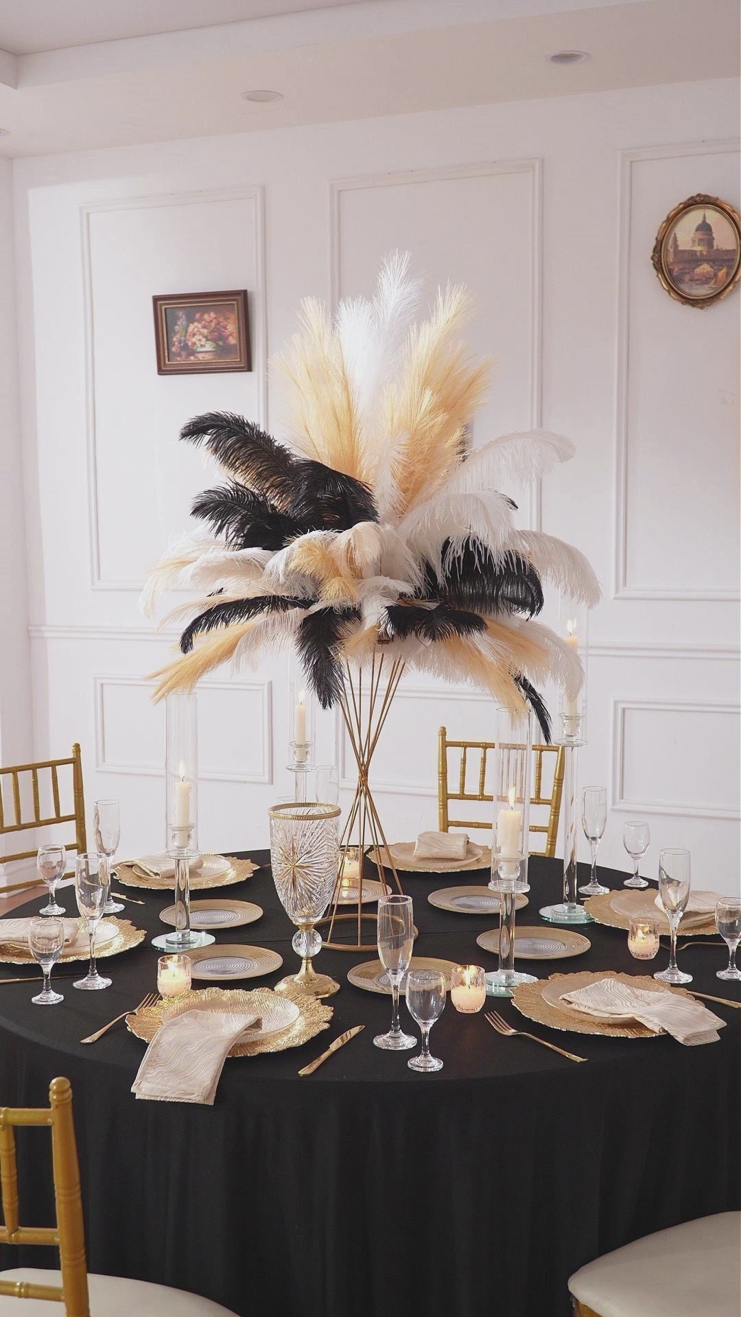 Ostrich feather arrangement displayed in vintage glossy gold candlestick vase