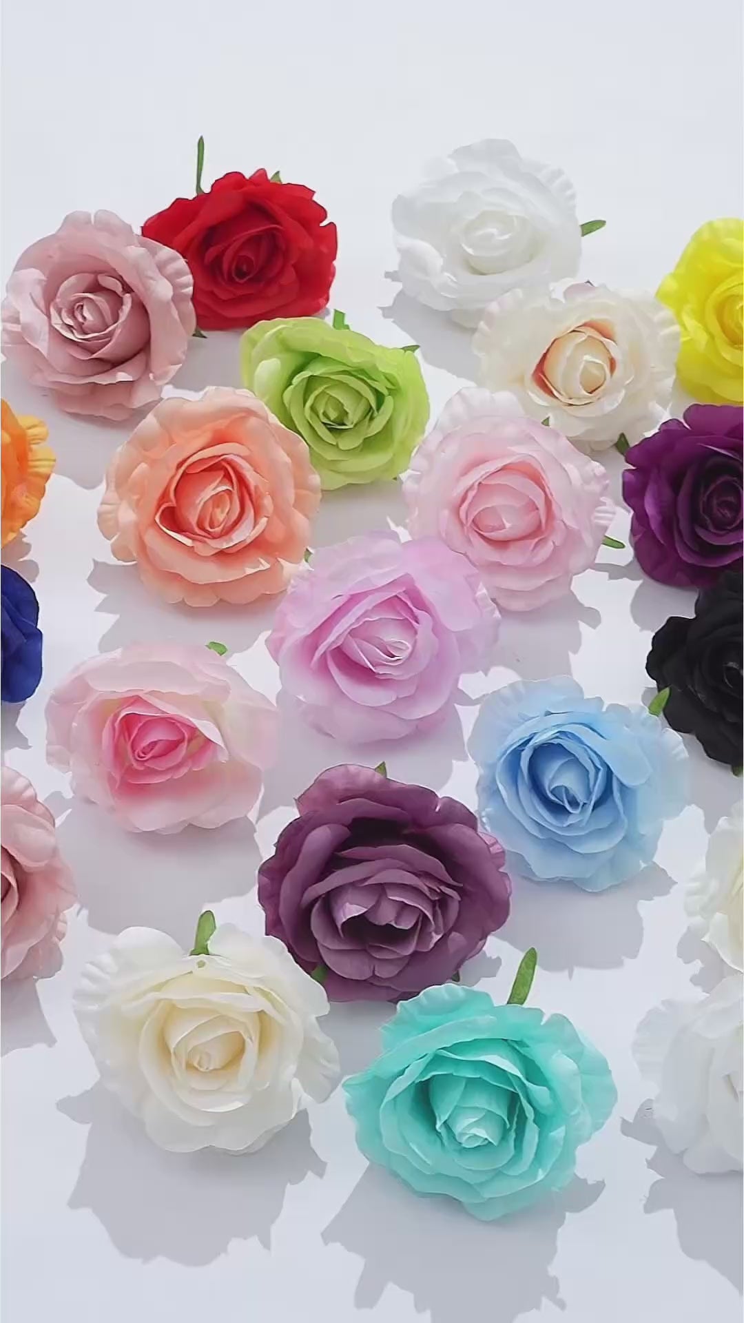 Assorted silk rose blooms in multiple colors for craft projects