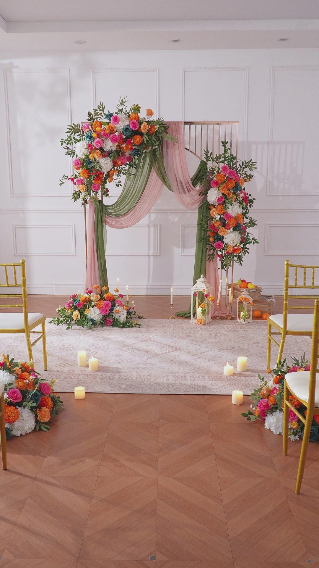 Garden wedding arch styled with sunset artificial flowers and drape