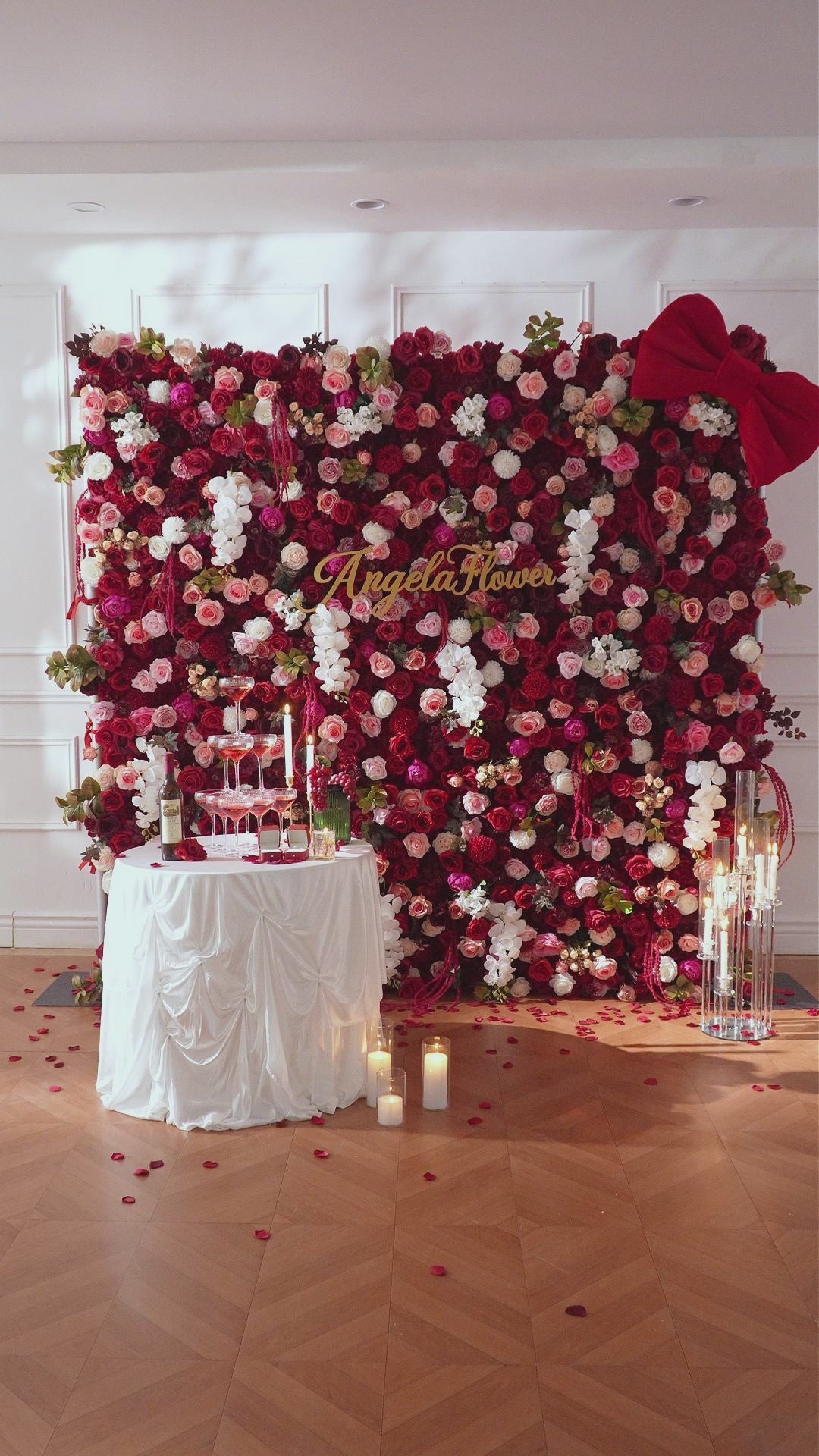 Dark red blush flower wall for outdoor waterfront wedding ceremony