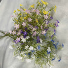 Faux wild daisy spray stem with delicate small blooms