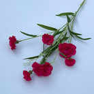 assorted‑color‑faux‑carnation‑bunches‑isolated‑white‑surface‑layout