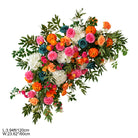 Wedding reception table setting with sunset floral centerpiece