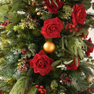 Pair of candle holder christmas table florals with red roses, evergreen foliage and gold ornaments