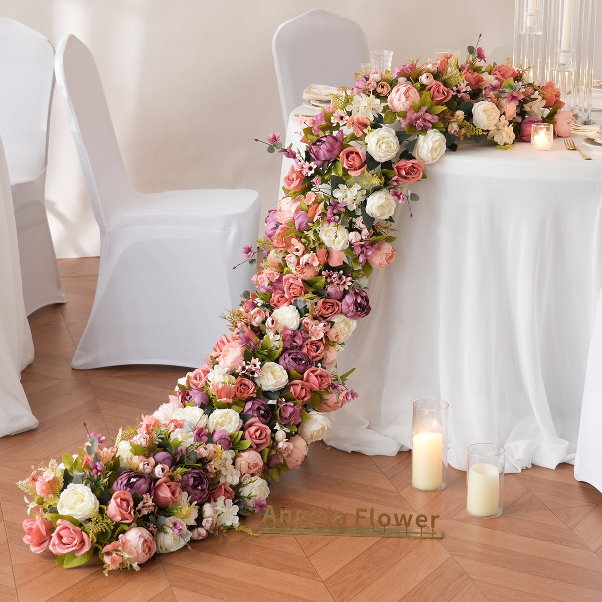 Indoor wedding reception setup with long trailing faux floral runner 