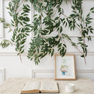 Rust faux eucalyptus leaf vine wedding aisle decoration