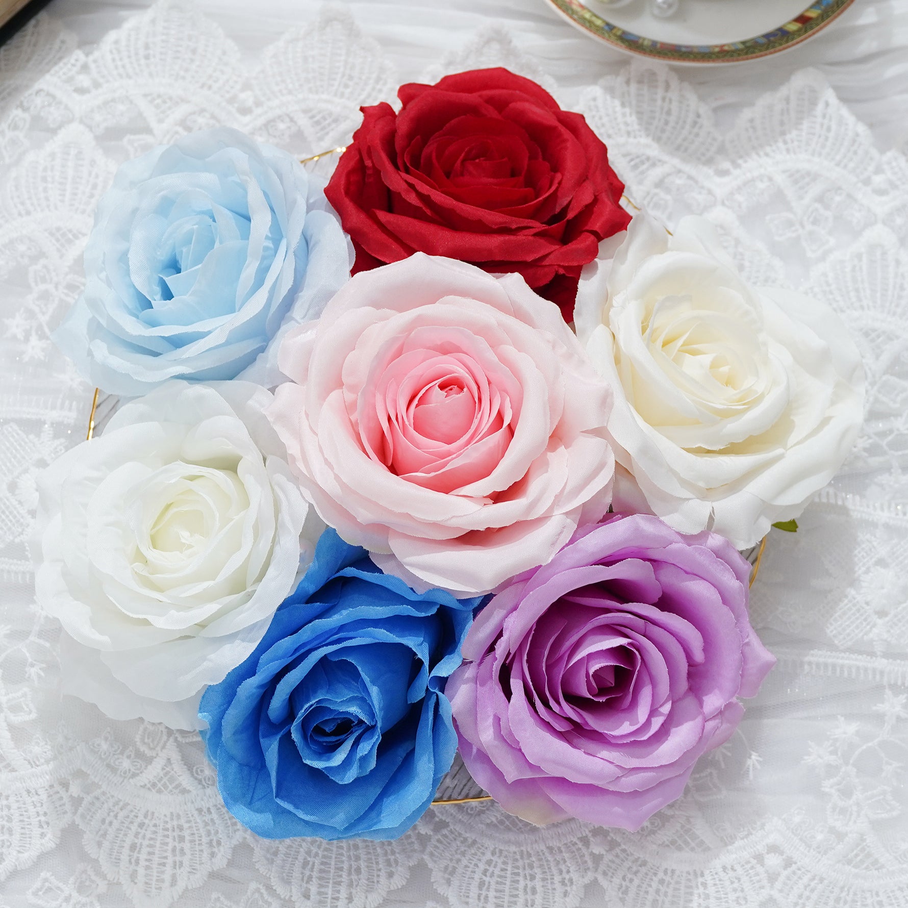 Mixed color artificial rose blooms displayed for floral design ideas