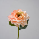 white_faux_dahlia_held_in_hand
