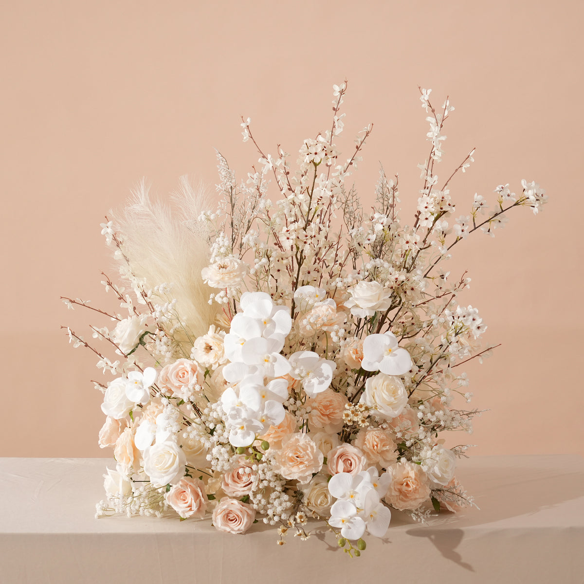 Wispy white filler branches add airy texture to champagne blooms