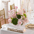 Long wedding dinner table styled with blush pink faux floral arrangements
