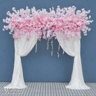 pink wisteria arch display against blue background