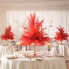 Voluminous feather bouquet held in polished gold decorative vase