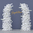 Dense packed white artificial blooms for full coverage wedding arch