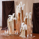 close up of textured faux white orchid and hanging amaranthus floral stems